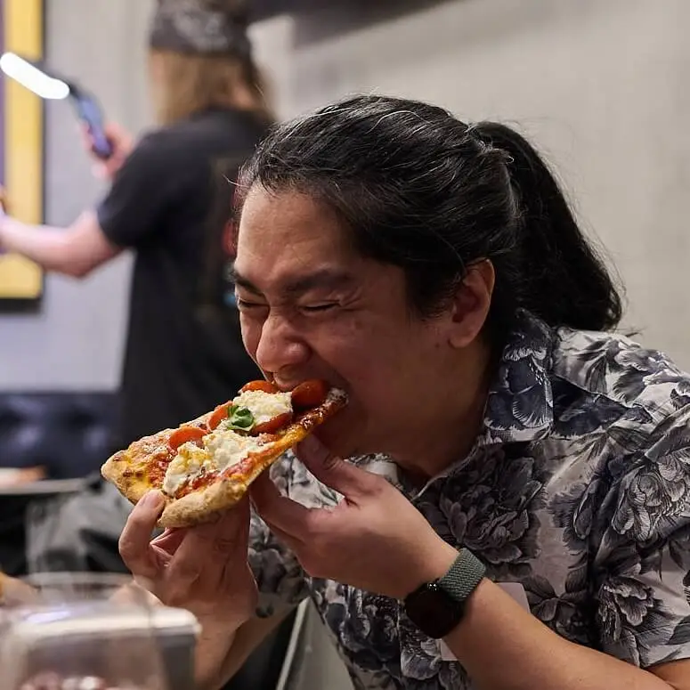 person eating pizza